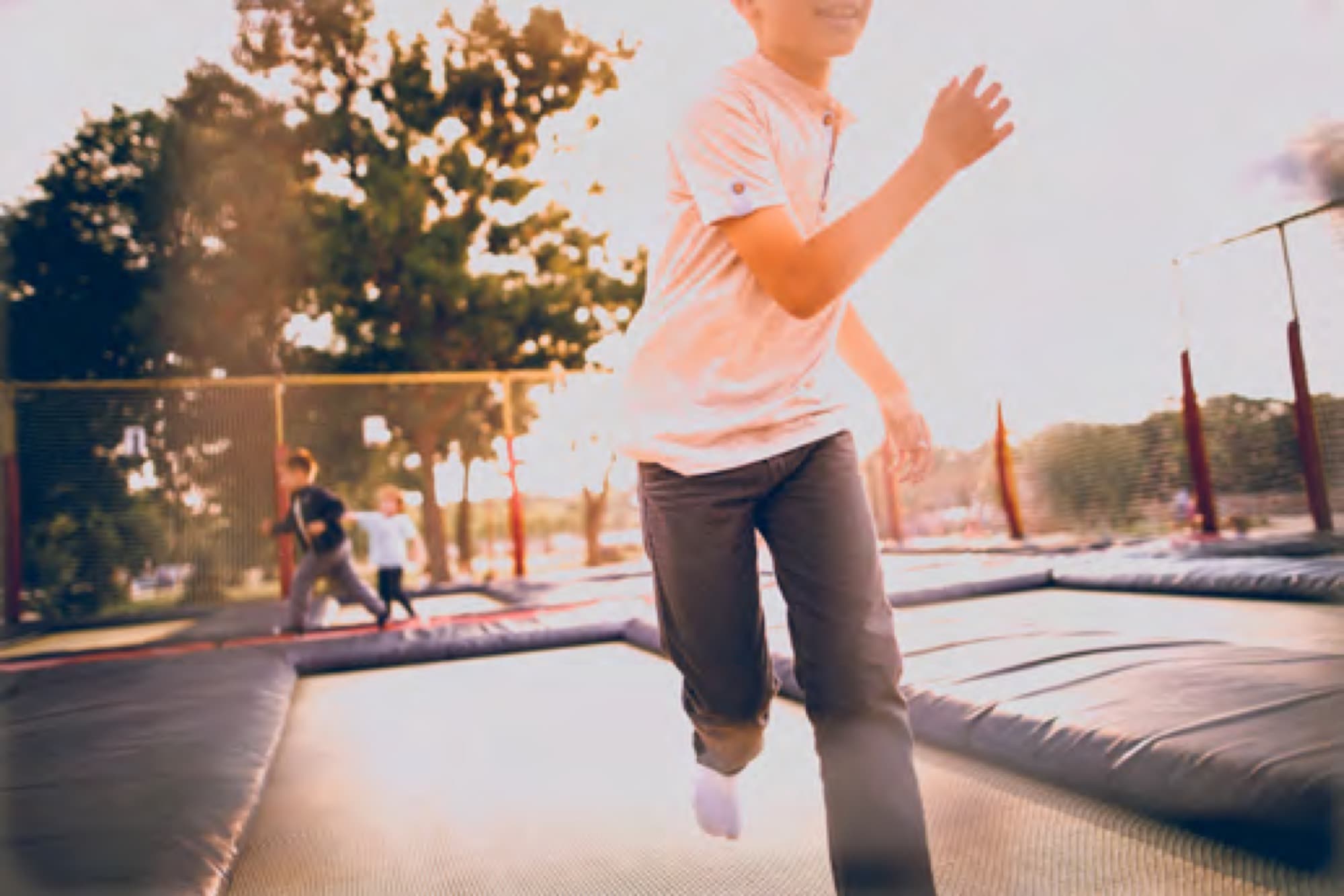 Boy leaping and playing at dusk, settling into family life in Arabian Ranches 3. AR3 Living is your go-to expert guide for moving your family to the community.