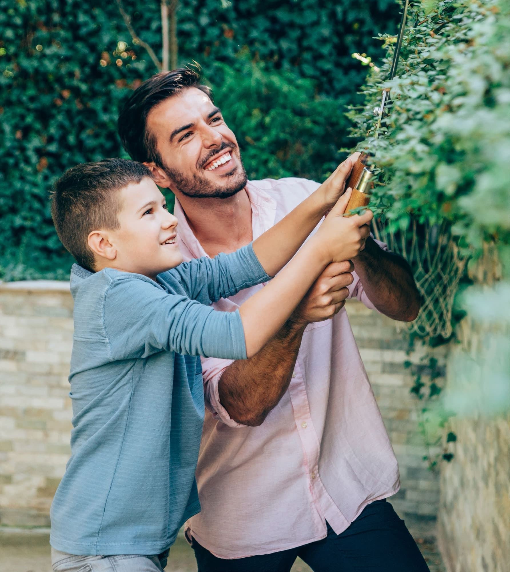 Father and son tending the garden together in Arabian Ranches 3. AR3 Living is your go-to on-the-ground expert for healthcare and clinics near the community.