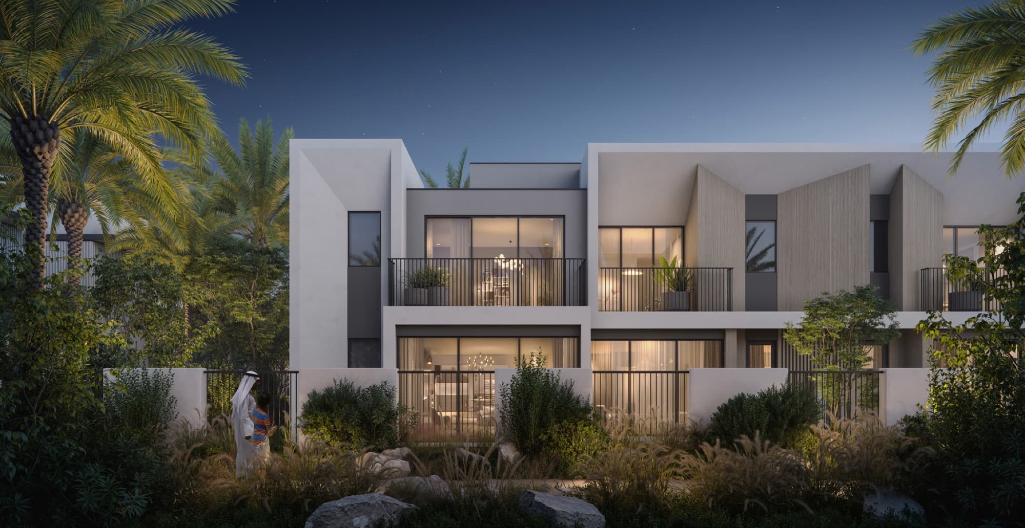 Evening exterior of an Anya townhouse in Arabian Ranches 3, a father and child at the garden gate with warmly lit rooms inside.