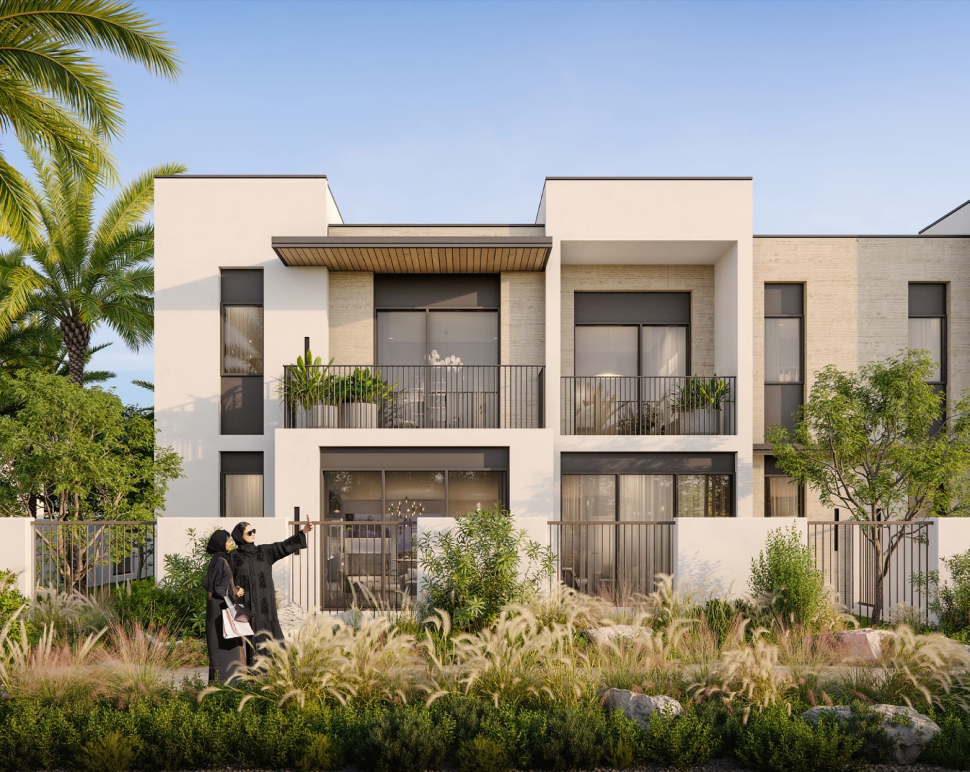 Anya 2 townhouses in Arabian Ranches 3, Dubai, beige stone façade with neighbours chatting and a cyclist passing.