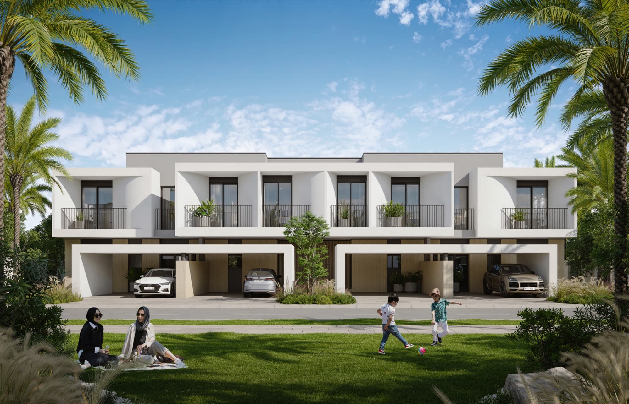 Daytime exterior of Anya 2 townhouses in Arabian Ranches 3, children playing football on the lawn in front of the homes.