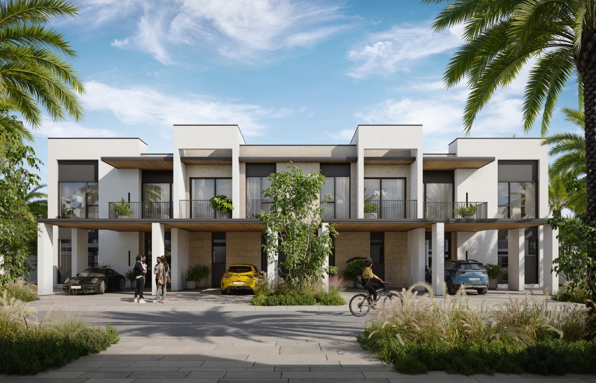 Anya 2 townhouses in Arabian Ranches 3, cream stone façade with a cyclist and residents on the tree-lined street.