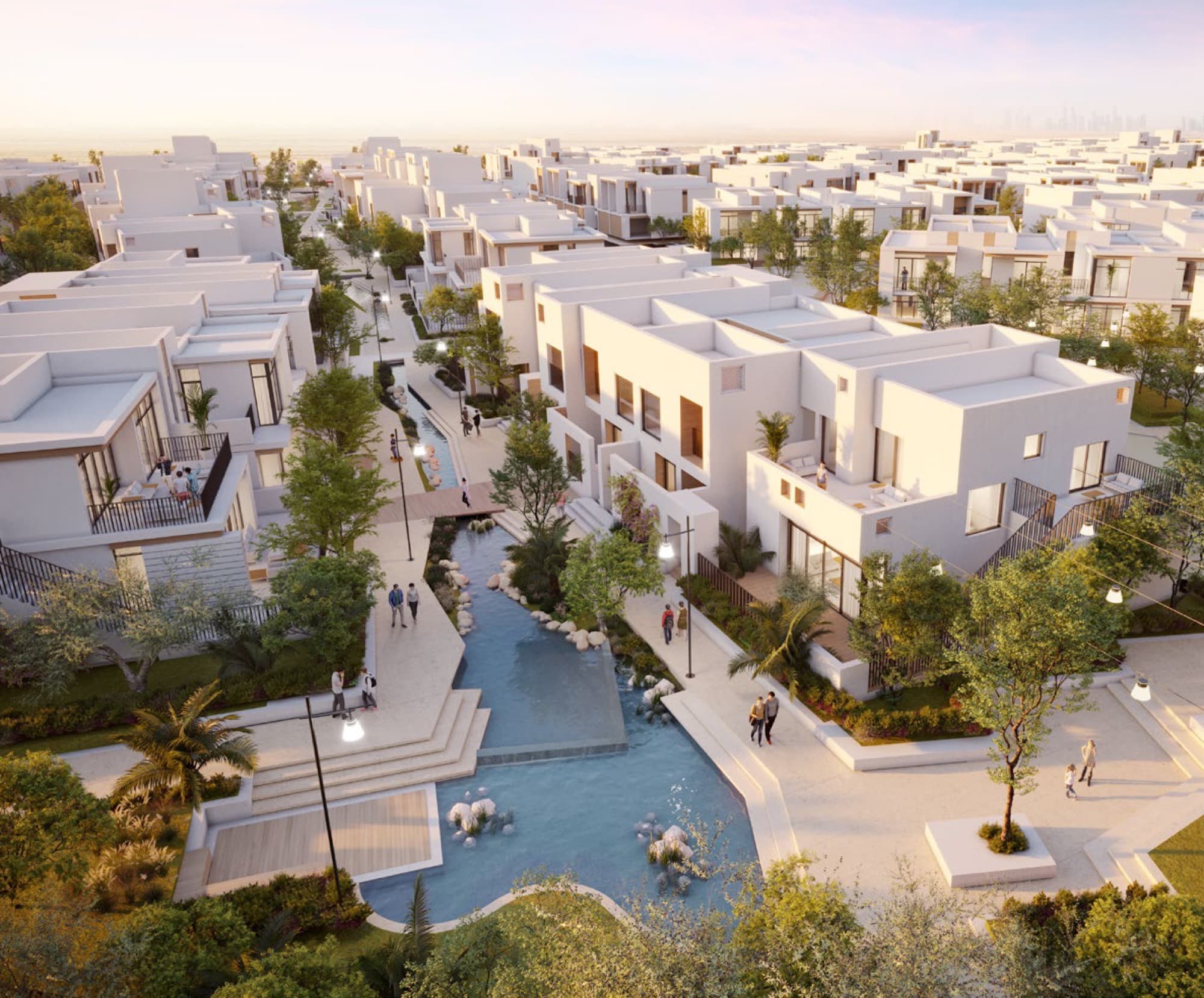 Aerial view of the Bliss townhouse cluster in Arabian Ranches 3, Dubai, with a central water feature winding through landscaped courtyards.