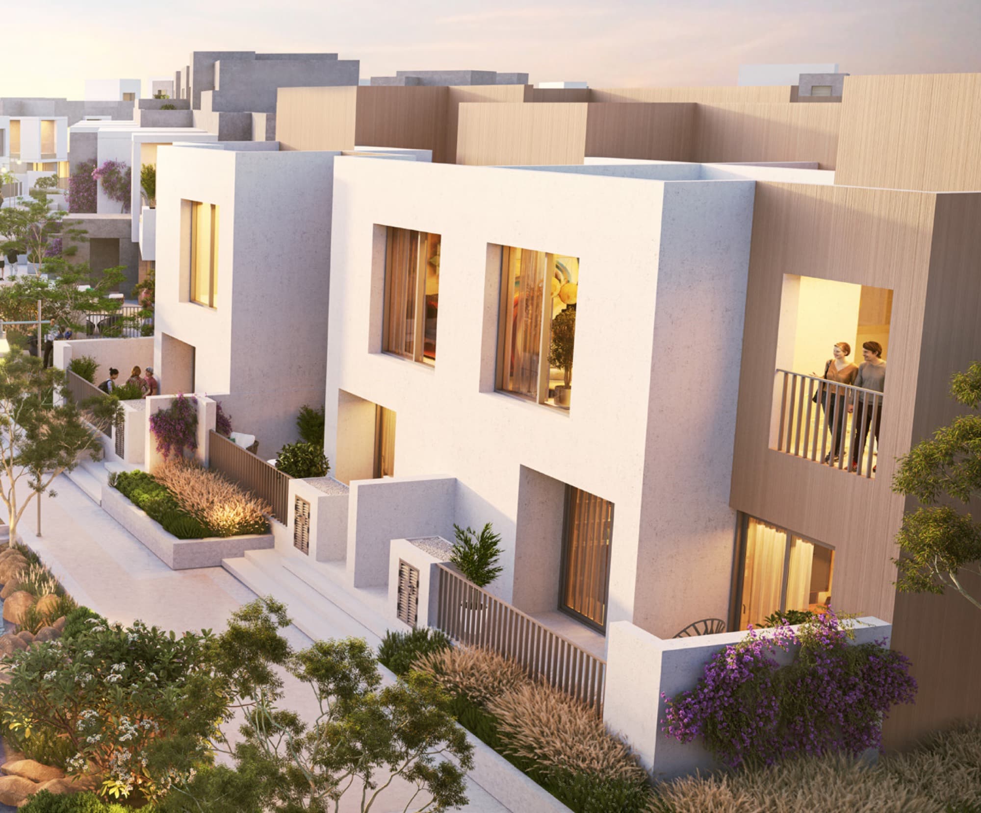 Aerial-angle view of Bliss 2 townhouses in Arabian Ranches 3, Dubai, at dusk with balconies overlooking a landscaped street.
