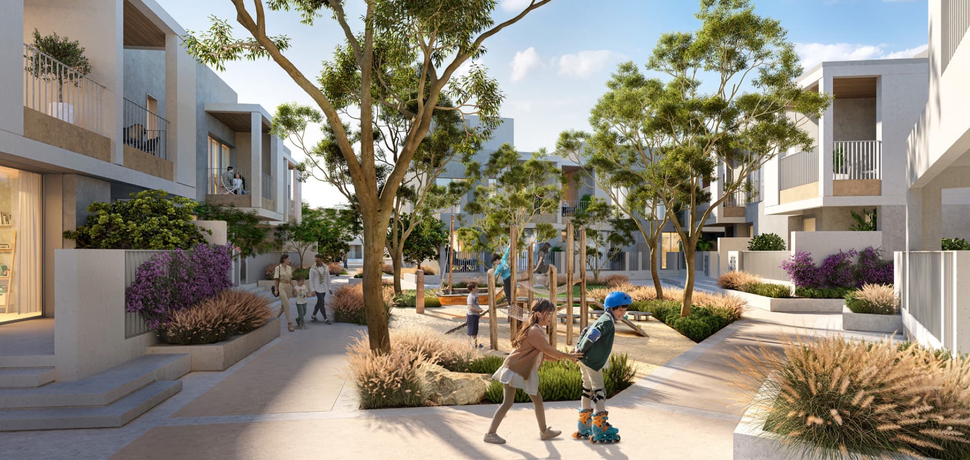 Children playing on a climbing frame in a landscaped play area within Bliss 2, Arabian Ranches 3, Dubai.