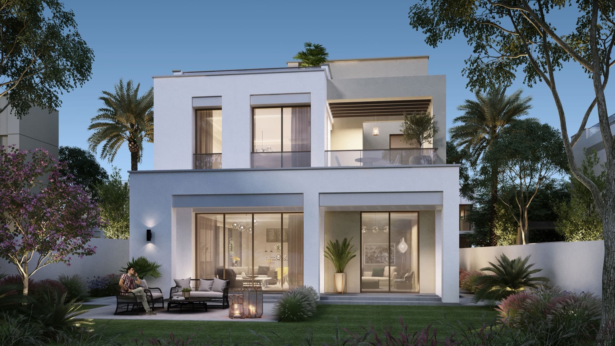 Rear garden view of a detached Caya villa in Arabian Ranches 3, Dubai, with full-height windows opening onto the lawn.