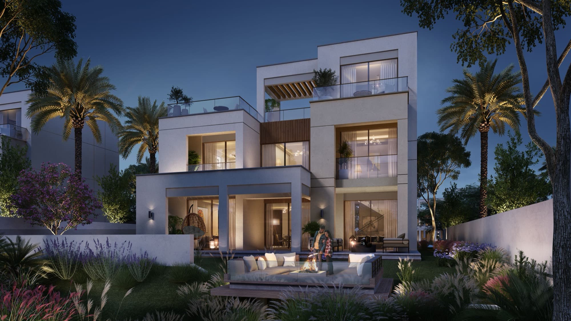 Detached Caya villa in Arabian Ranches 3, Dubai, lit at dusk with an open rooftop terrace and glass balustrade.
