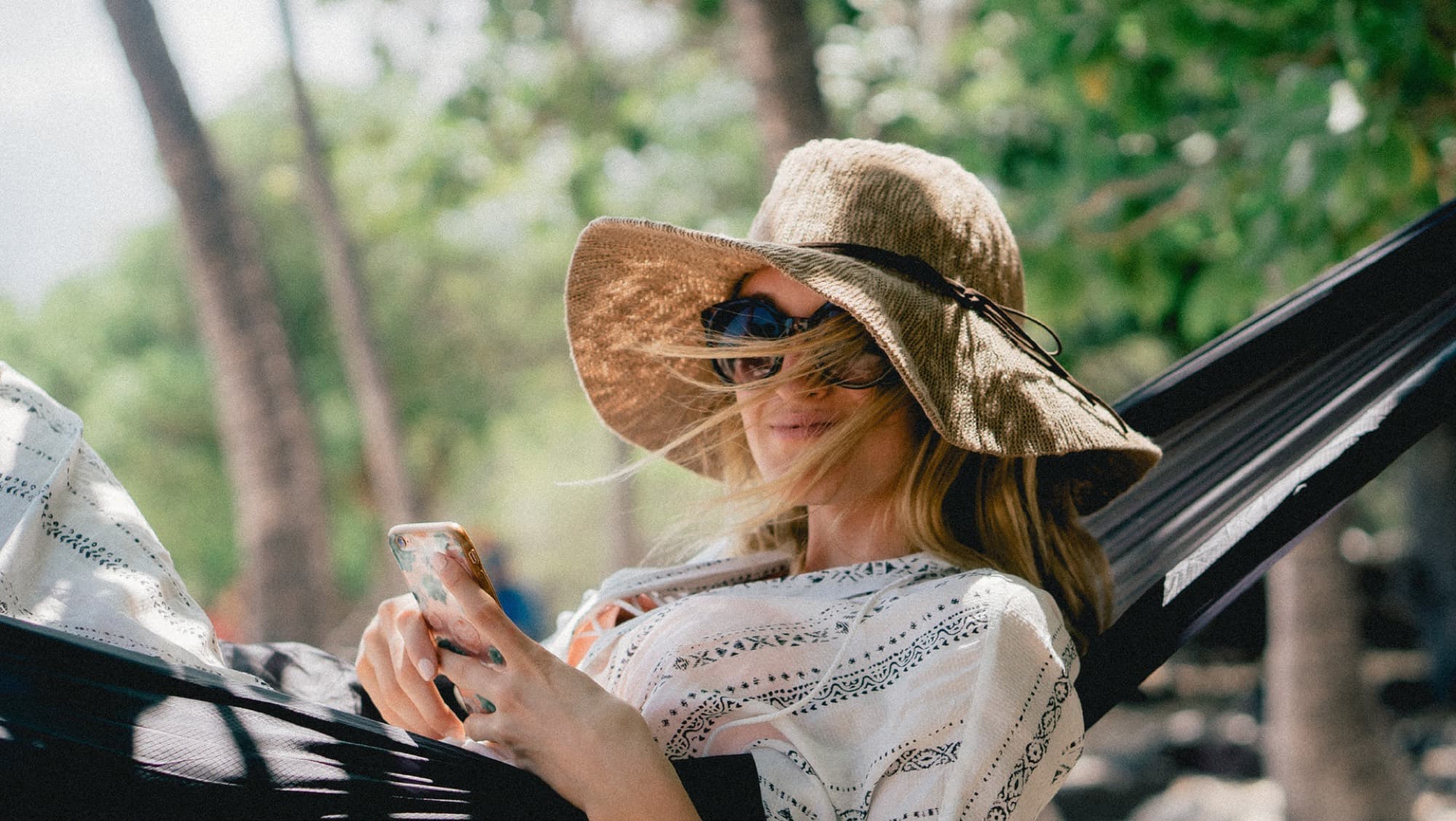 Resident relaxing in a garden hammock, part of the lifestyle imagery for Caya 2, Arabian Ranches 3, Dubai.
