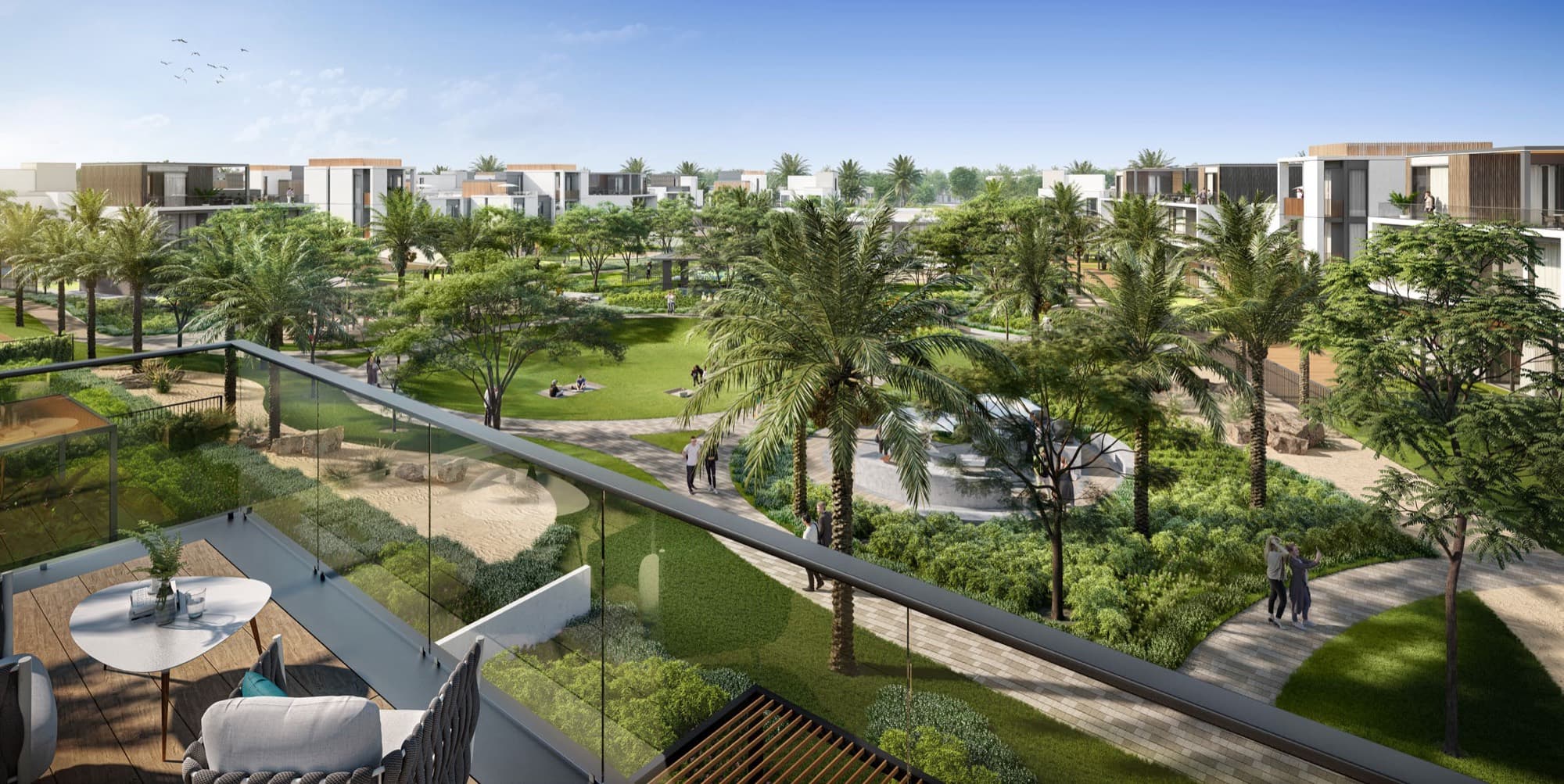 Aerial dusk view of the landscaped park at Elie Saab Villas, Arabian Ranches 3, palm-lined paths leading toward the villas.