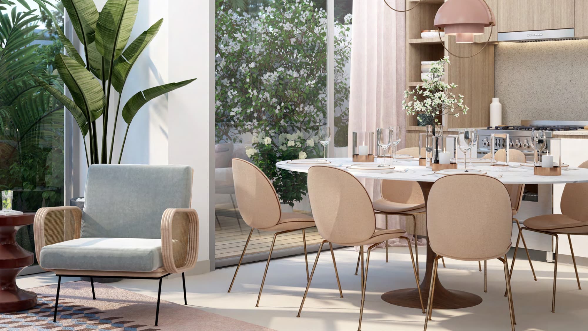 Open-plan dining area and kitchen with blush-toned chairs in a Joy townhouse, Arabian Ranches 3, Dubai.
