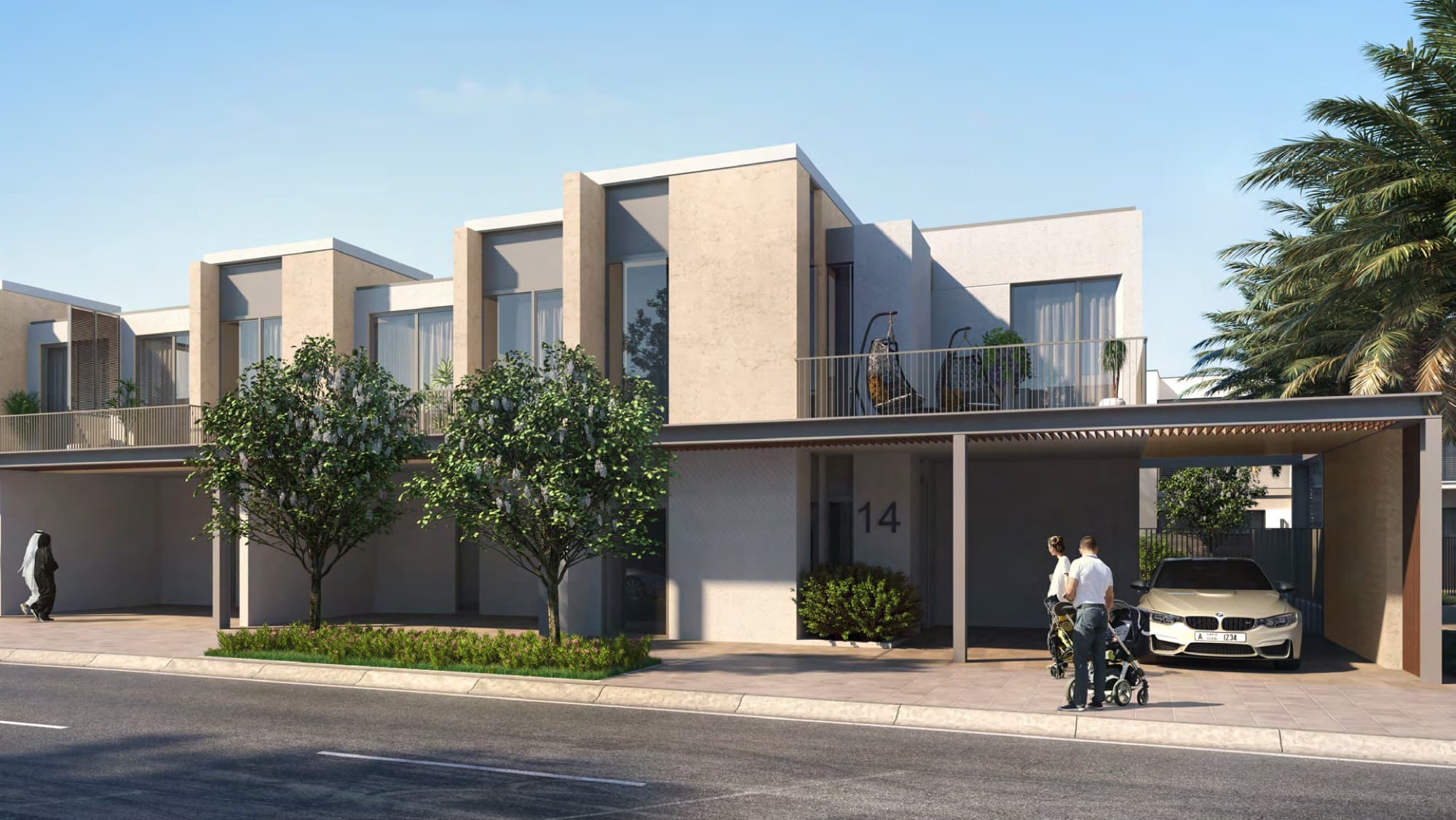 Two-storey Joy townhouse with balcony, carport and family with a pram out front, Arabian Ranches 3, Dubai.