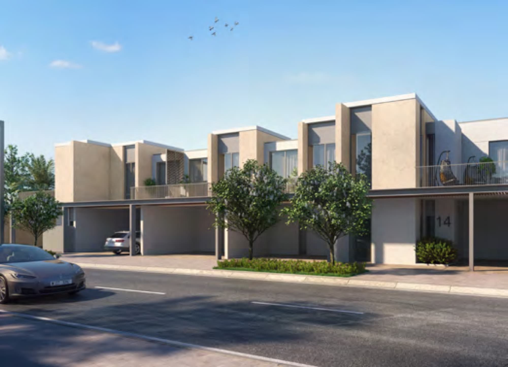 Row of contemporary Joy townhouses with timber-clad balconies and tree-lined pavement, Arabian Ranches 3, Dubai.