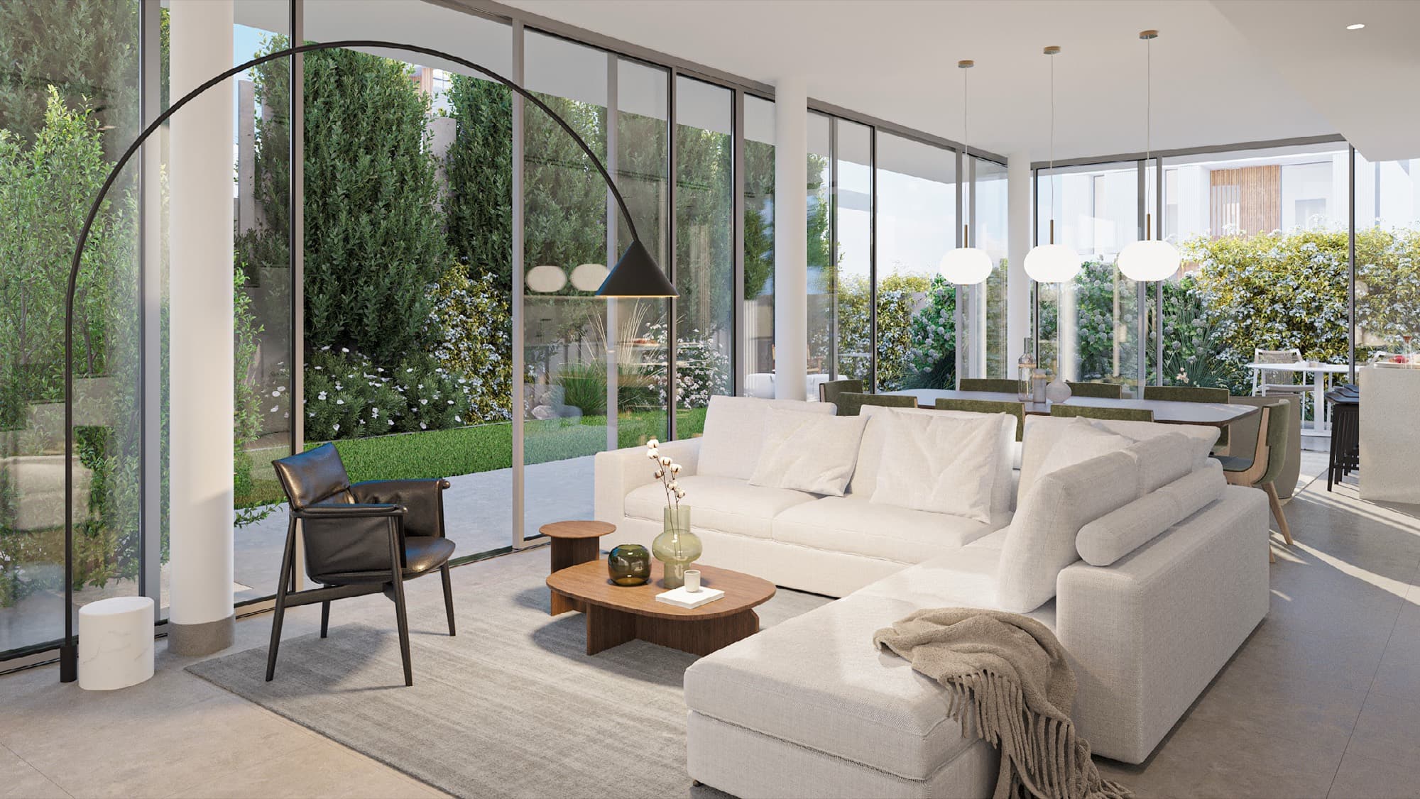 Open-plan living room in a June villa, Arabian Ranches 3, Dubai, with a corner sofa facing full-height glazing onto the garden.