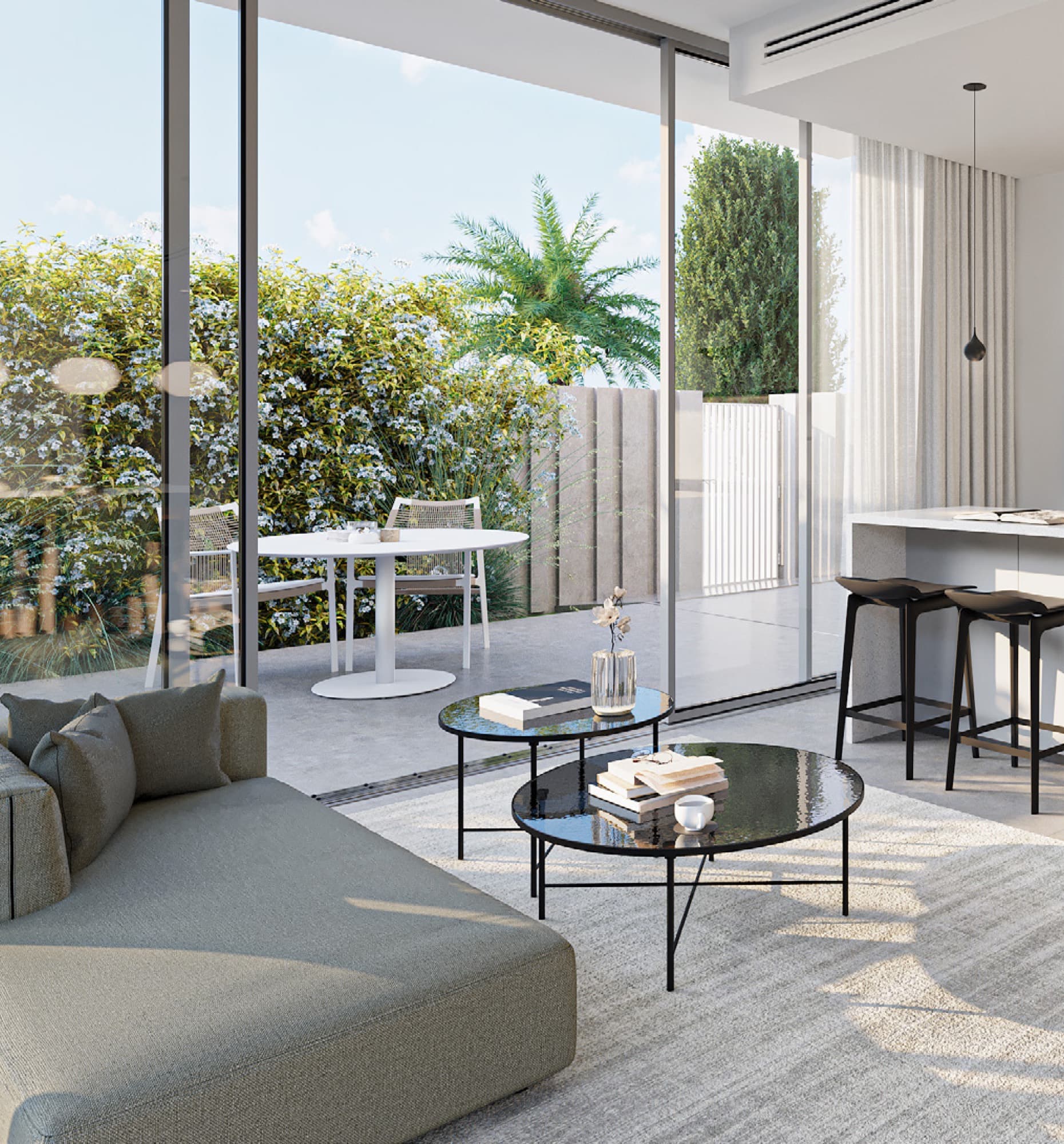 Living and dining area in a June villa, Arabian Ranches 3, Dubai, with a green corner sofa beneath the staircase to the upper floor.