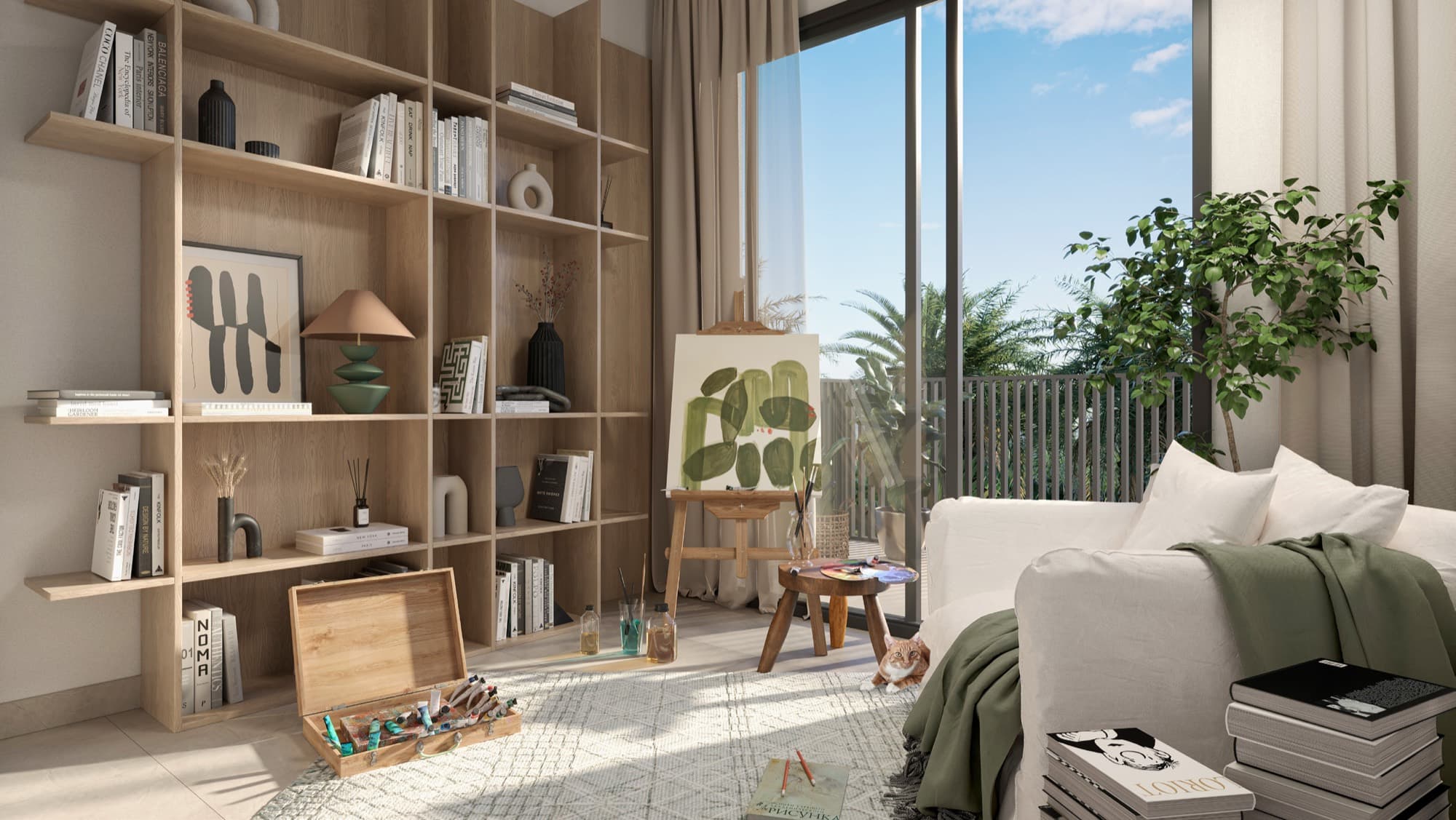 Home studio nook in a May townhouse, Arabian Ranches 3, Dubai, with a bookshelf, easel and sofa beside the balcony window.