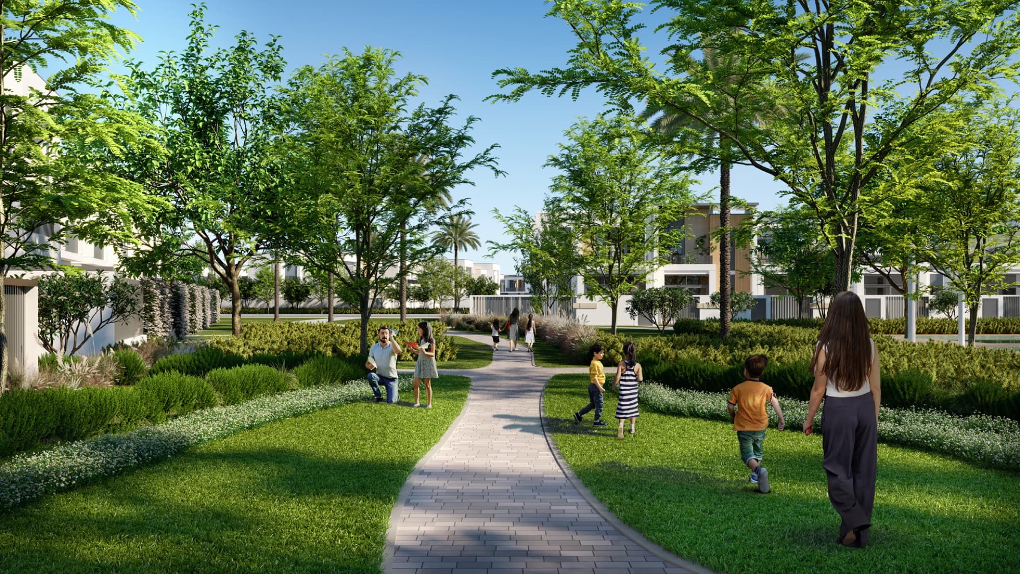 Families and children walking a landscaped pathway through Raya, Arabian Ranches 3, Dubai, past townhouse rows.