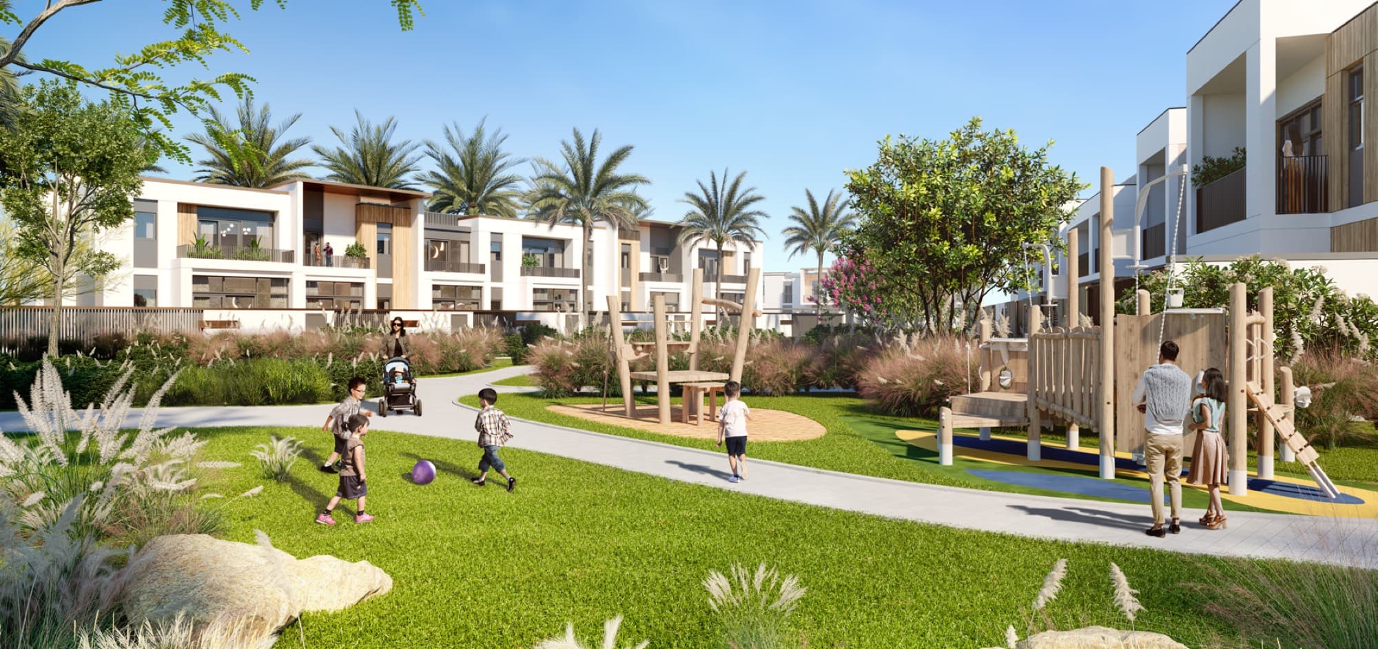 Children's playground with climbing frame in Raya, Arabian Ranches 3, Dubai, backed by townhouse rows and palm trees.