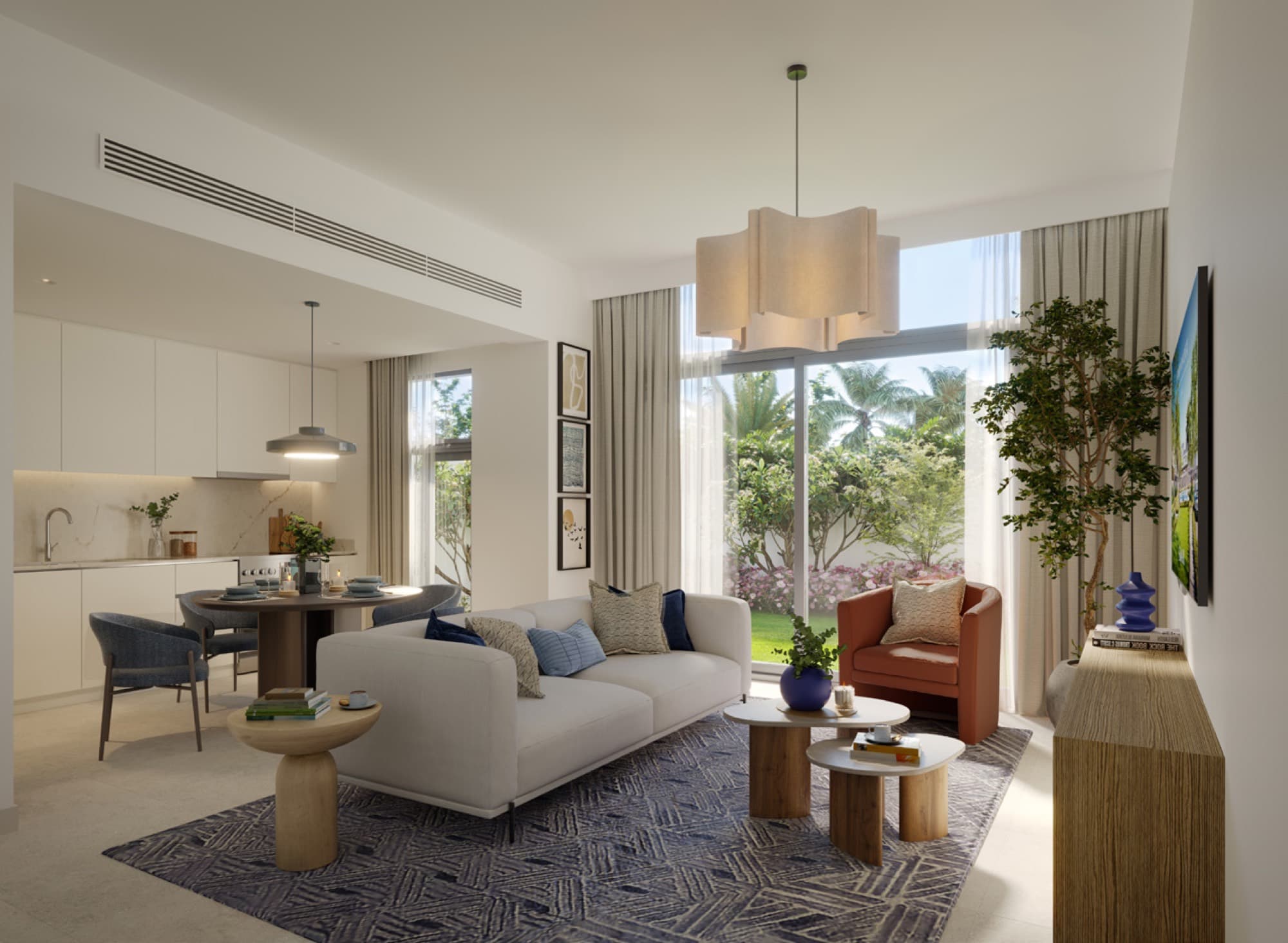 Open-plan living and dining area in a Raya townhouse, Arabian Ranches 3, Dubai, with garden views through floor-to-ceiling windows.