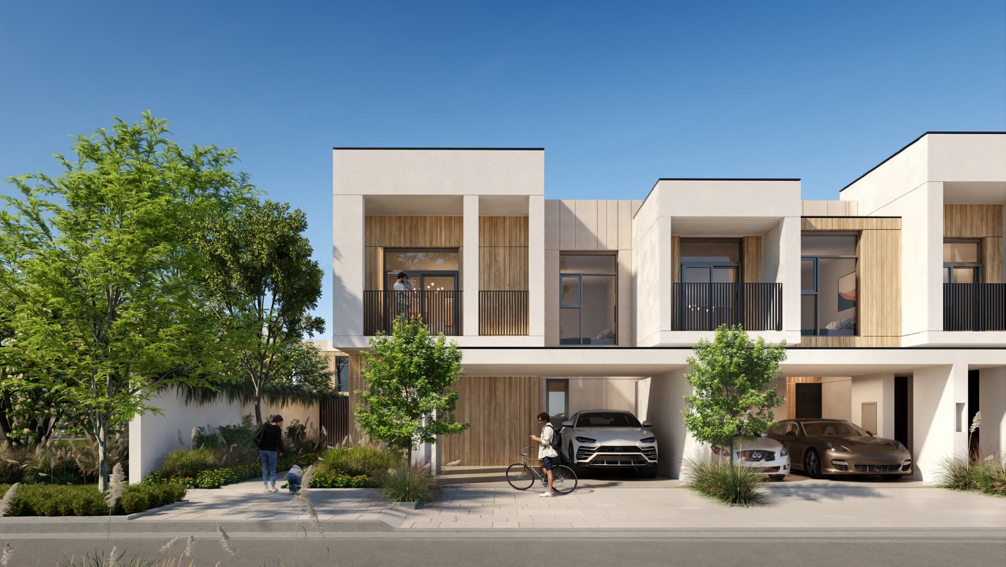 Twin townhouse façade in Raya, Arabian Ranches 3, Dubai, with a resident and cyclist on the driveway.