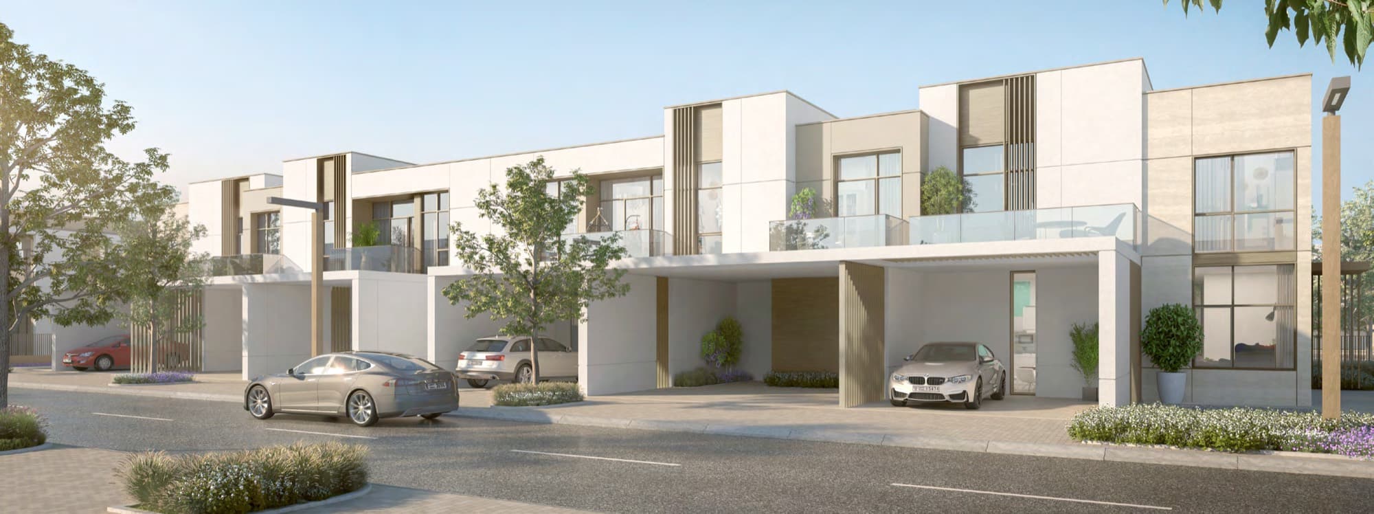 Row of Ruba townhouses with covered parking and cars along the kerb, Arabian Ranches 3, Dubai.