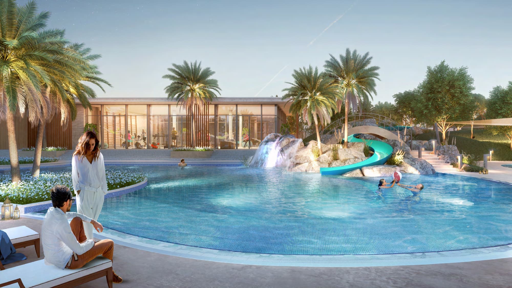 Evening view of the Ruba community pool with waterfall, slide and clubhouse, Arabian Ranches 3, Dubai.