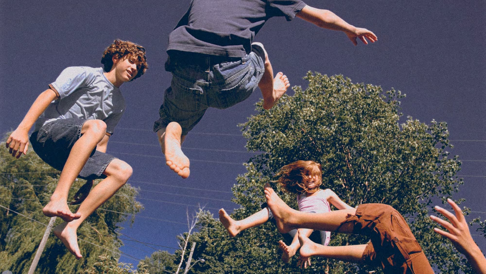 Children mid-air on a garden trampoline at Spring townhouses, Arabian Ranches 3, Dubai.