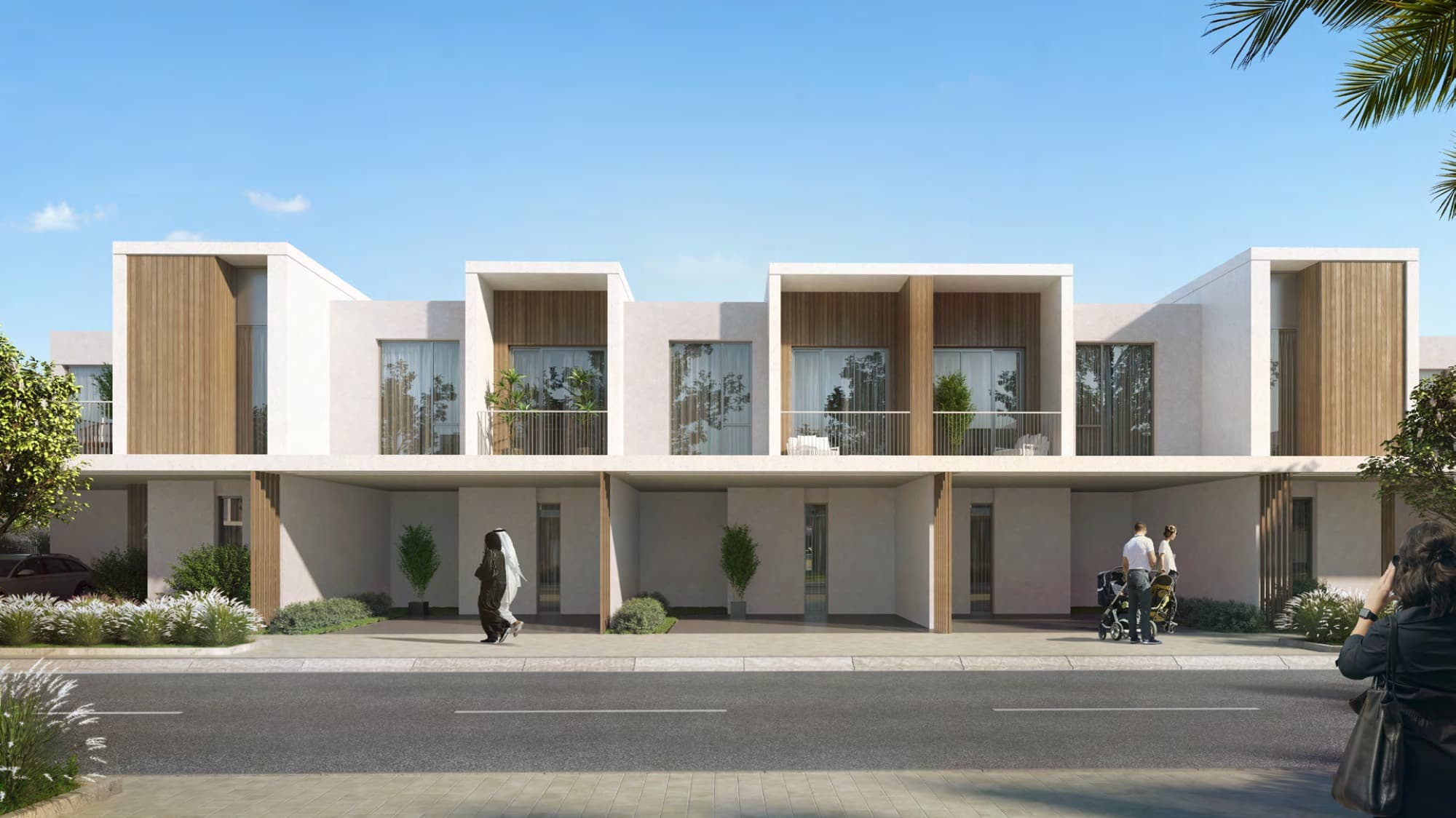Row of Spring townhouses with wood-slatted balconies and ground-floor carports, Arabian Ranches 3, Dubai.