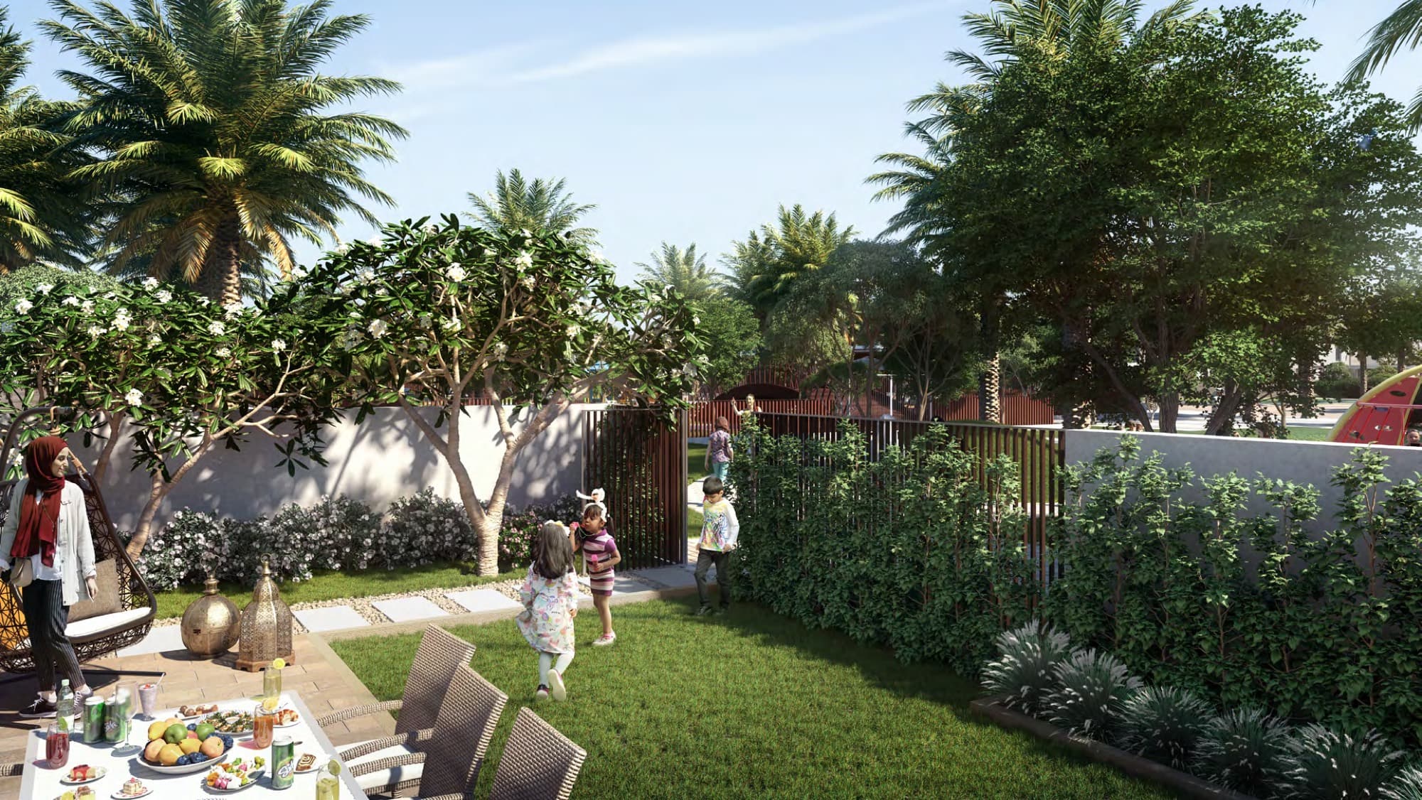 Family relaxing in a landscaped back garden near a playground gate at Sun townhouses, Arabian Ranches 3, Dubai.